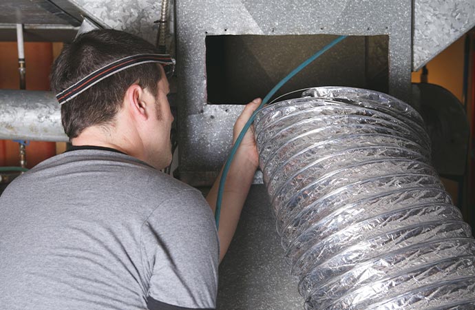 a ventilation cleaner man at work with tool