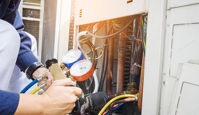 Professional worker checking freon levels