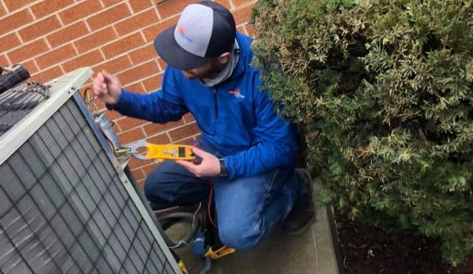 Authorized  technician repairing outdoor ac unit