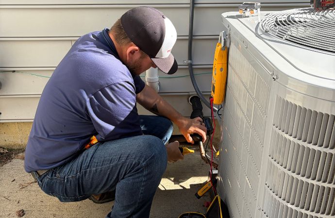 hvac technician working on outdoor air conditioner