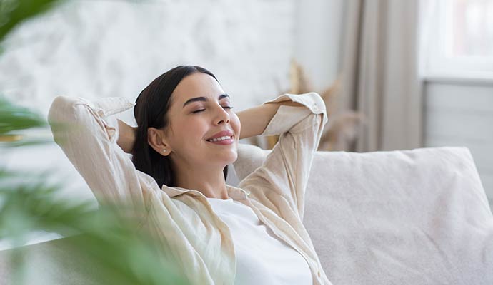 Woman relaxing good indoor air quality in living room