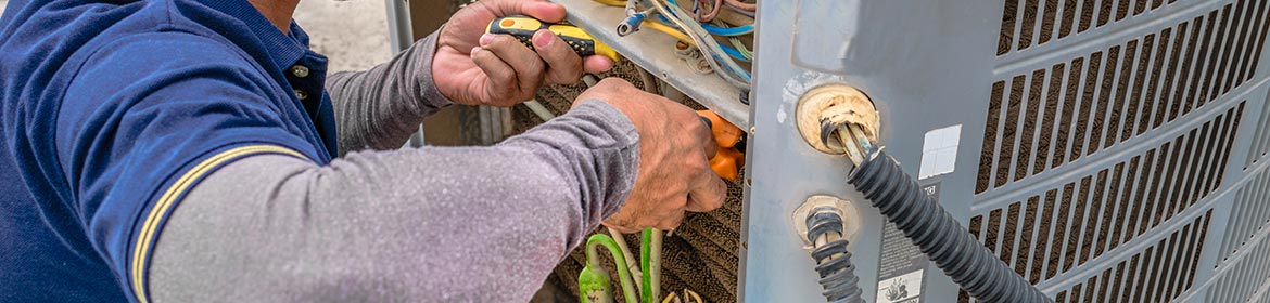 worker repairing ac