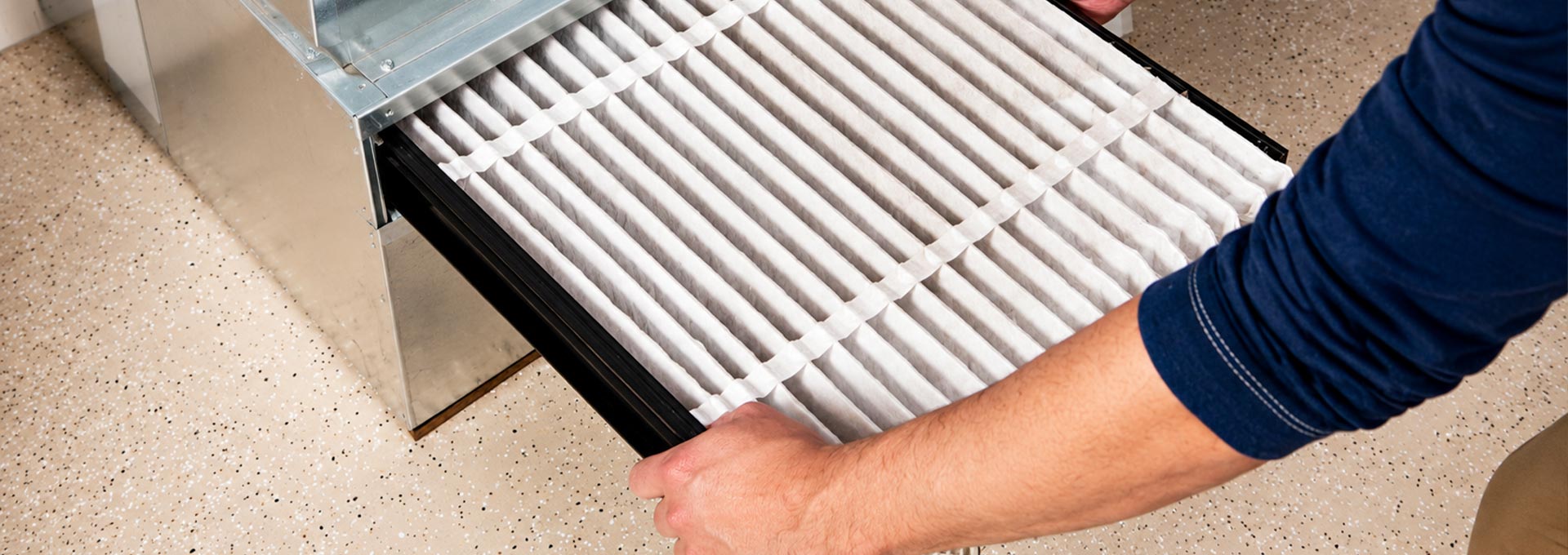 Technician installing an HVAC air filter