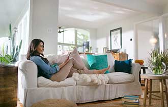 women seating in the living room talking on the phone