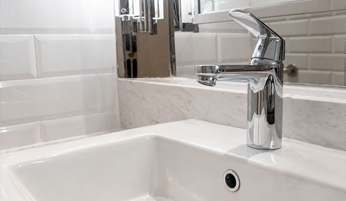 Chrome faucet on white ceramic bathroom sink