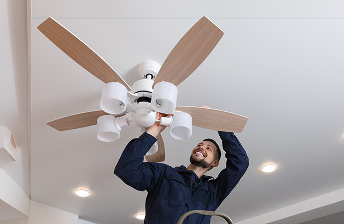 Electrician repairing ceilling fan