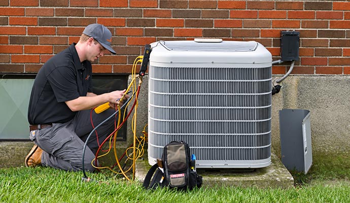 Expert inspecting outdoor heat pump unit