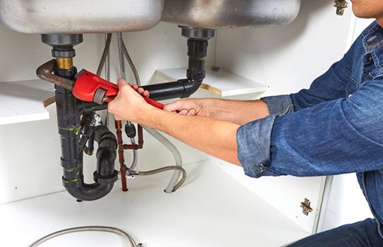 Technician repairing sink