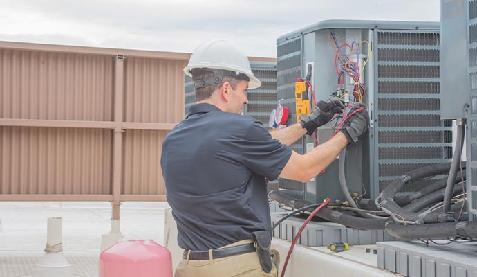 Experts Technician repairing a commercial heating unit