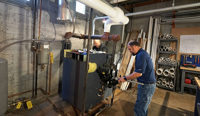 Technicians repairing a heating system