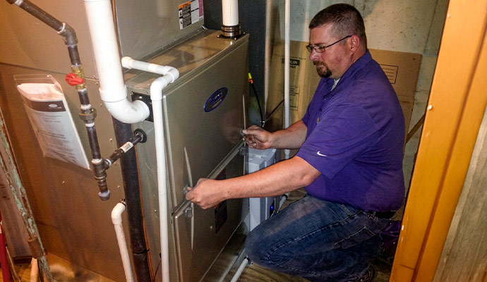 Experienced professional resolving furnace problems at home for efficient heating