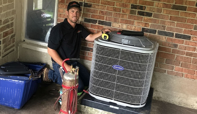 Technician repairing carrier HVAC unit
