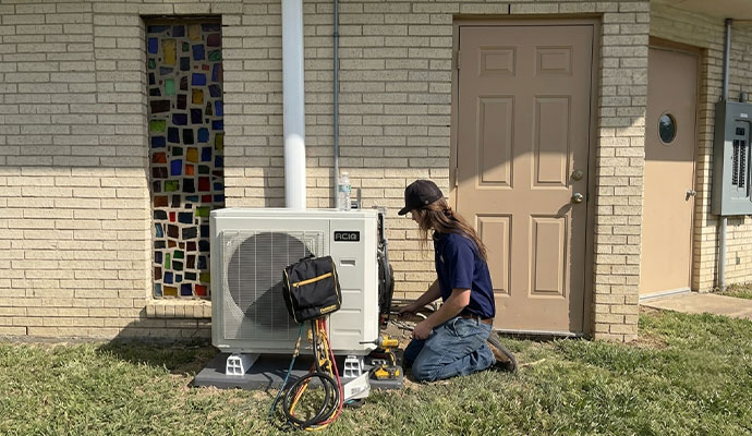 Technician repairing outdoor AC unit