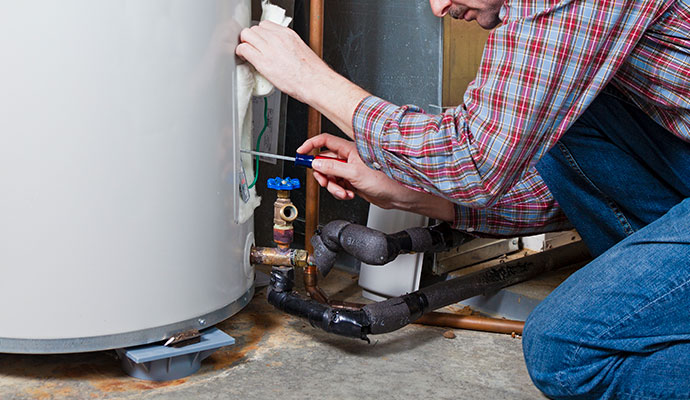 Technician repairing water heater