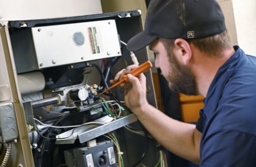 hvac technician performing a furnace tune-up