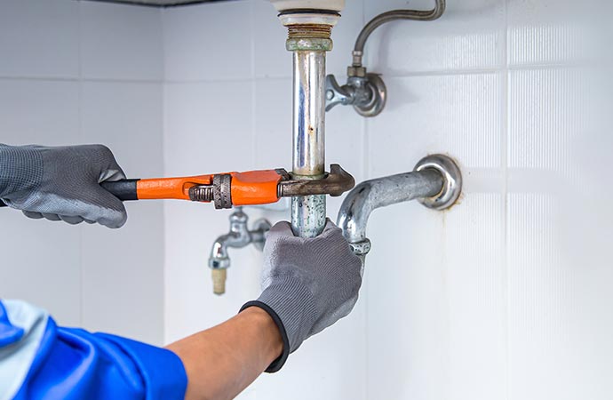 plumber repairing faucet and related things