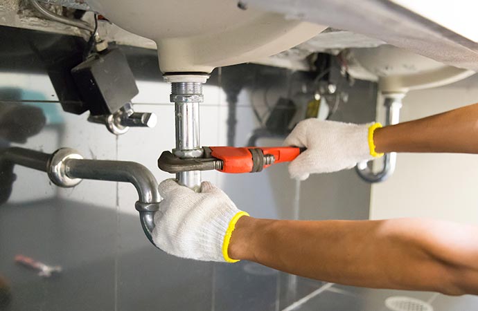 Professional worker installing bathroom plumbing