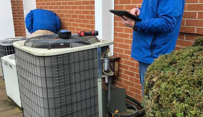 Professional worker maintaining AC