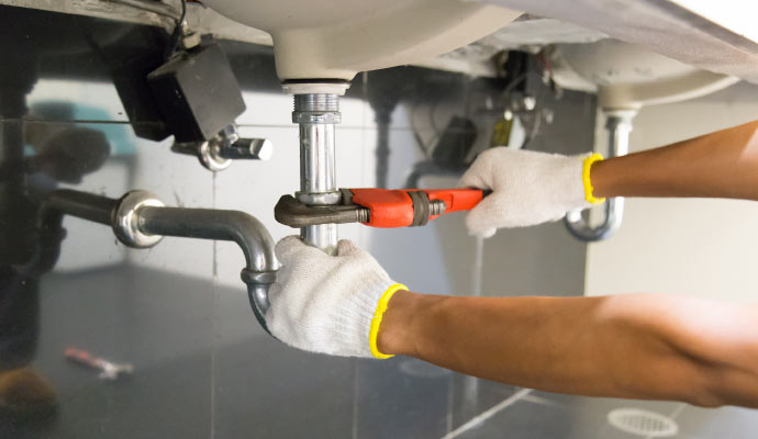 Plumber repairing kitchen sink