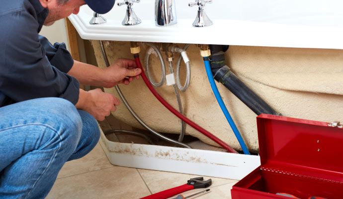 plumber fixing bathtub
