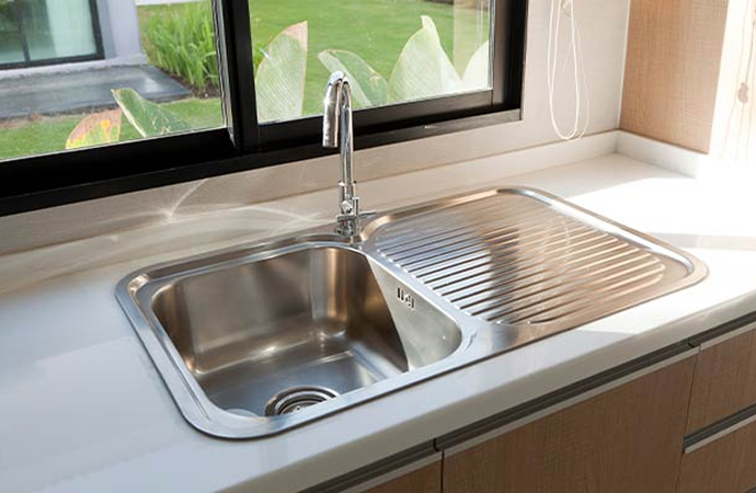 Residential kitchen sink with a modern faucet