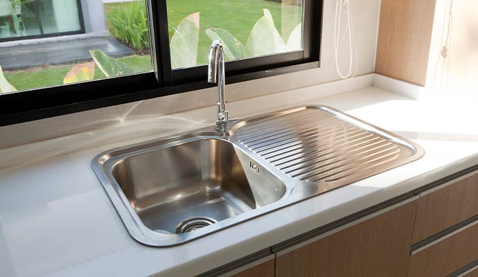 Residential kitchen sink with a modern faucet