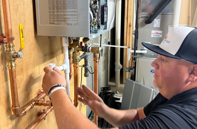 Professional worker installing a tankless water heater