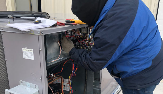 professional worker repairing air conditioner