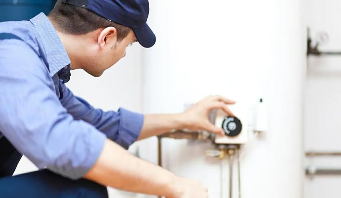 Professional worker repairing water heater