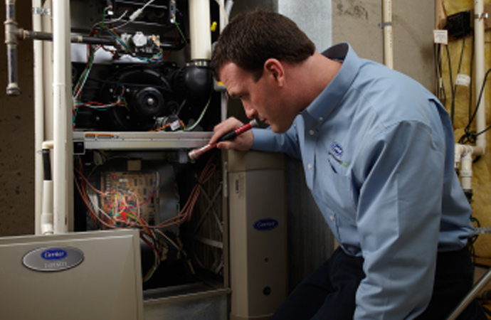 Skilled professionals inspecting malfunctioning furnaces for repair services.