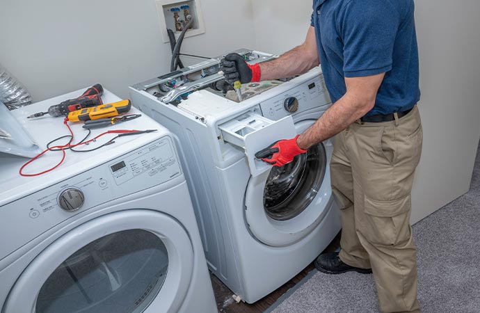 Professional worker installing washing machine