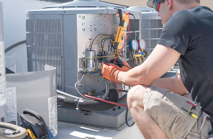 Technician repairing air conditioner