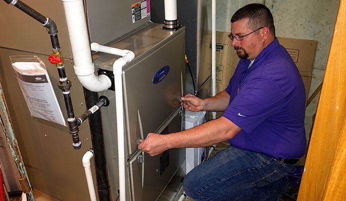 Technician servicing residential furnace
