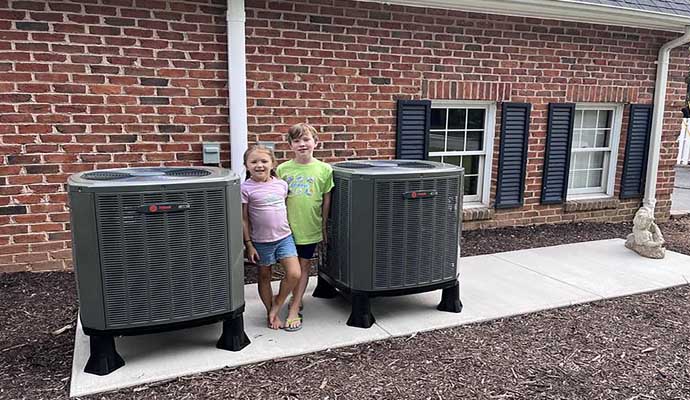 Trane air conditioning units placed on a concrete slab