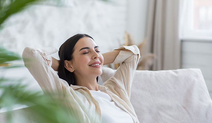 Woman relaxing at home enjoying clean indoor air quality