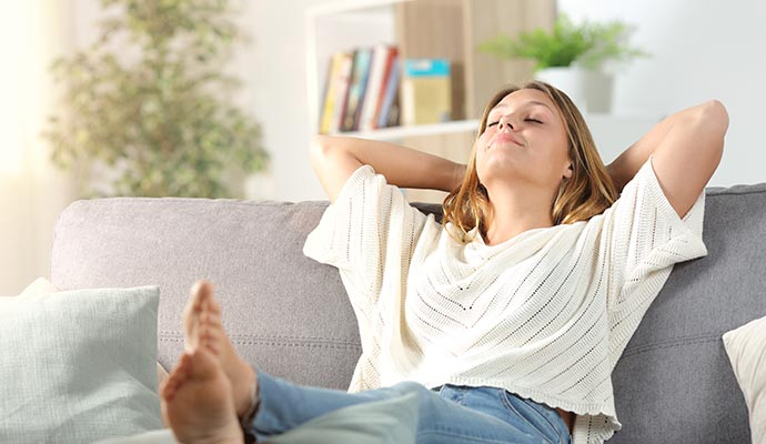 Woman relaxing in a living room with fresh indoor air
